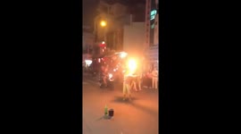 The woman performing with fire on the busy road