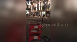 Mind the windows! Workmen play football off London's Regent Street