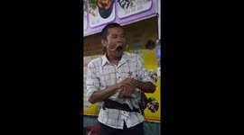 The man performing with knife and sword on the street