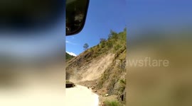 Terrifying moment bus passengers scream after getting stuck yards from landslide