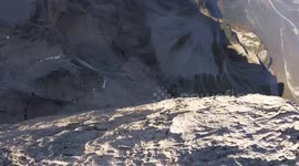 Wingsuit diver basejumps off Petit Ferrand mountain in French Alps