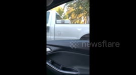 Garbage truck falls into sinkhole