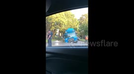 Garbage truck falls into sinkhole