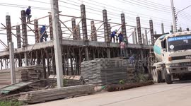 Teamwork on a construction site, in Thailand.