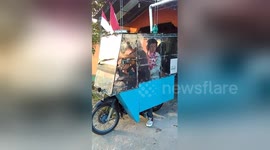 Easy drier! Moped rider keeps family out of rain with bizarre contraption