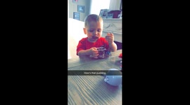 Baby gets pudding all over his face