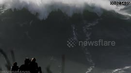 Surfer rides Gigantic Wave and suffers a Massive Wipeout at Nazaré, Portugal during the first XXL size swell of the Season