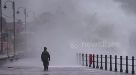 UK wave watcher gets drenched by mountain of white water