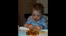 Messy baby eating, & wearing pasta.
