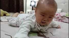 Cute frustrated baby learns to crawl for the 1st time