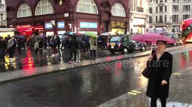 Rain in Oxford st Bus in puddle