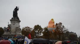 Trump baby blimp joins thousands at Paris protests