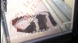 Chinese woman swallowed up by sinkhole while walking along pavement