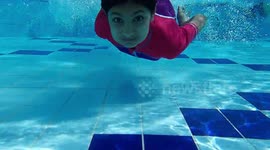 Child swimming under water