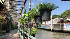 Passenger Boat speeding down a klong in Bangkok