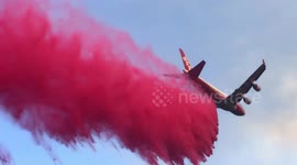 Footage shows air tanker dropping long stream of retardant to fight Camp Fire