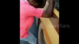 Indian student travels dangerously on rim of moving bus wheel