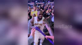 Young fan freaks out when LeBron hands his arm sleeve to him