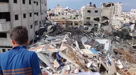 Palestinians inspect ruins of Hamas TV station after Israeli air strike on Gaza