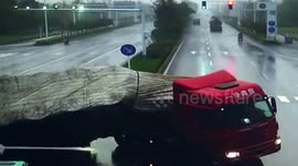 Oblivious scooter rider escapes being crushed by out-of-control lorry