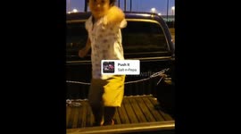 Salt n Peppa dancing toddler in back of pick up truck