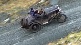 Vintage cars driven up steep hill-climb in the Lake District