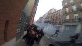 Riot police use tear gas to disperse protesters