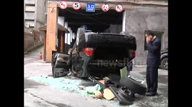 Driver crashes through first floor window