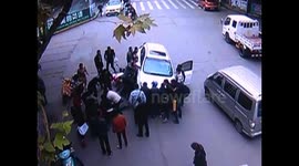 Passersby lift car off trapped woman