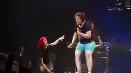 Fan falls over while singing on-stage at Paramore gig