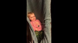 Contagious baby laughter and this baby asks to be swung inside of her blanket