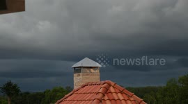 'Windy Day' Time lapse video with dark clouds over small house