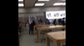 Funny guy dances with headphones in Apple store