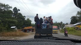 Soccer fans in Indonesia pack open truck in ride to stadium