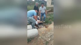 Boy trapped in concrete pipe is smashed out by his dad