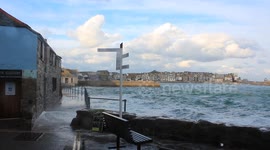 Blustery St Ives with waves crashing over the sea defences