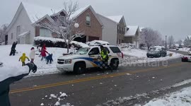 Friendly police join in snowball fight with neighbourhood kids