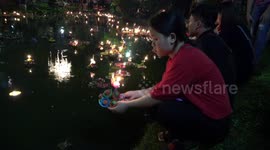 Thai people celebrate annual 'Festival of Lights' by floating lit candles downriver