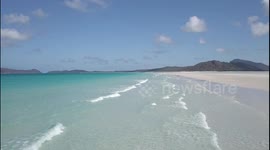Whitsunday Islands - Whitehaven Beach at Low Tide - Drone Video Wave Fly By
