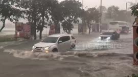 Cars drive through flooded streets of Pattaya, Thailand, as rainstorm hits
