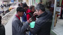 Footage shows local Tijuana shop owner serving food to Honduran migrants