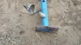 Team of snake rescuers rescue out a snake trapped inside a pipe after a marathon operation of 40 minutes in Odisha, India