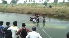 Up to 25 'school students' are killed after a private bus plunges into canal in southern India - as boy who jumped from the bus is believed to be a lone survivor