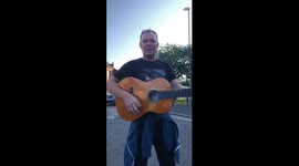 Drunk man at 6am singing on a guitar