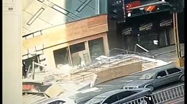 Giant billboard blows over onto pedestrians