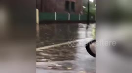 Cars drive on flooded roads as torrential rain lashes Sydney