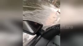 Cars drive on flooded roads as torrential rain lashes Sydney