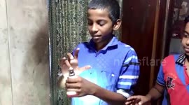 Wonder boy lights LED bulbs without electricity by touching them with his hands