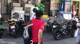 Thai man playing triple neck guitar on the street