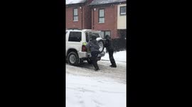 Truck gets towed by a car in snow